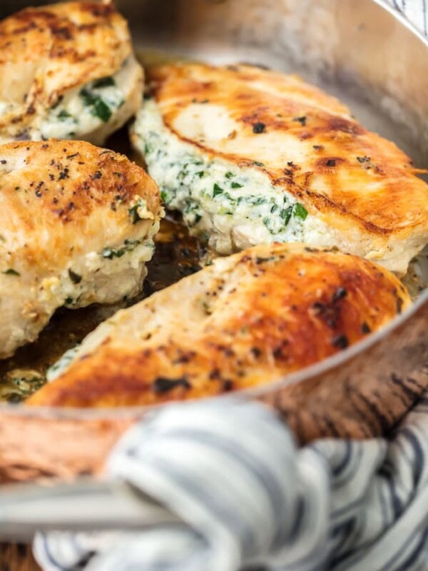 Spinach Stuffed Chicken Breast is a 3 INGREDIENT CHICKEN RECIPE that's healthy (around 400 calories), made in under 30 minutes, and done in just ONE PAN! This Spinach Stuffed Chicken Breast is one of our all-time favorite Stuffed Chicken Breast Recipes. Cheesy, delicious goodness.