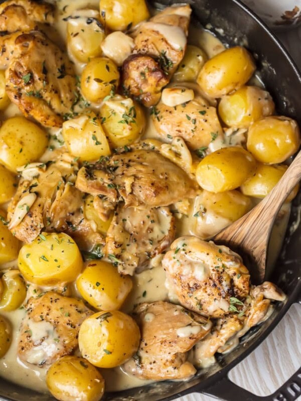 40 Clove Garlic Chicken and Potatoes with Cream Sauce has totally and completely rocked my world. We are obsessed with this Chicken with 40 Cloves of Garlic! Garlic Chicken and Potatoes with Cream Sauce is all the rage right now...so why not add some garlic (or 40 cloves of garlic, to be exact) for the ultimate Garlic Chicken and Potatoes? This is the best chicken recipe of all time!