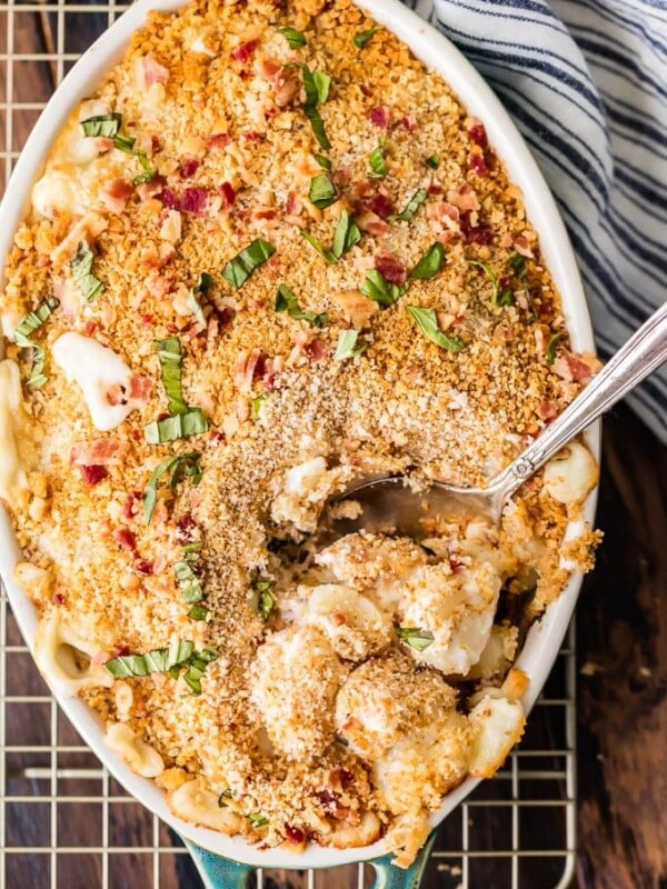 Cheesy Bacon Gnocchi Bake with a spoon on a wire rack