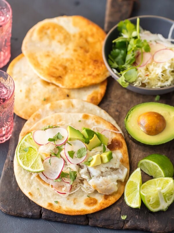 Cod Fish Tacos are so fresh and delicious. The flavors in these Margarita Fish Tacos are off the hook! Citrus from limes, oranges, and tequila brighten the cod fish flavors and when mixed with the acidic slaw these just cannot be beat. This Cod Fish Taco Recipe is the ultimate light recipe to start off the new year. Healthy can be just as delicious as this creative Tex-Mex recipe proves.