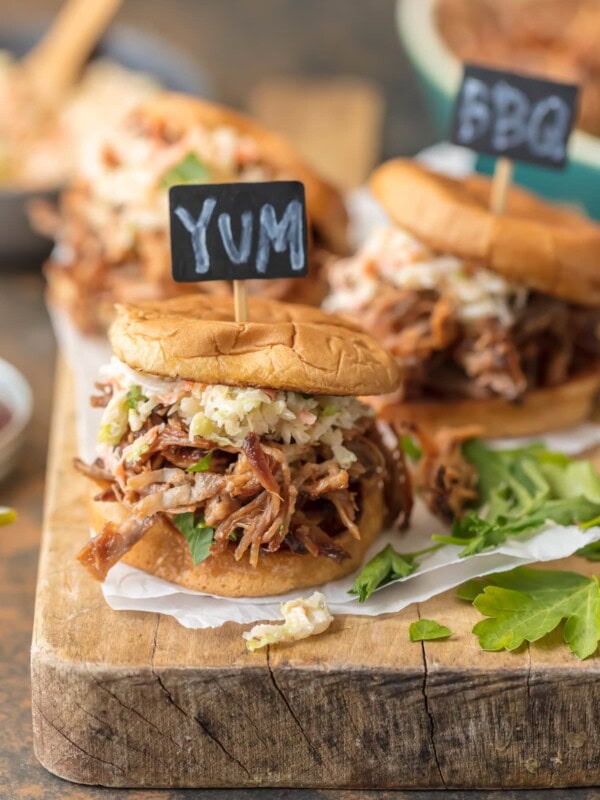 Crockpot BBQ Pork Sandwiches are a must make recipe for any busy family. These SLOW COOKER BBQ PORK SANDWICHES are the ultimate fun finger food for any party! Use the meat for sliders, stuff them into quesadillas, or eat it over rice. The possibilities are endless!