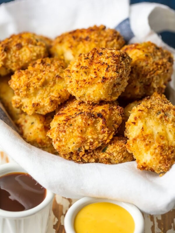 Baked Chicken Nuggets are a must make for any busy family. These BAKED EXTRA CRISPY PARMESAN CHICKEN NUGGETS will blow your mind and become an instant family favorite. Made healthier by baking instead of frying, you'll never miss the grease. Kids and adults will be requesting these flavorful Homemade Chicken Nuggets again and again!