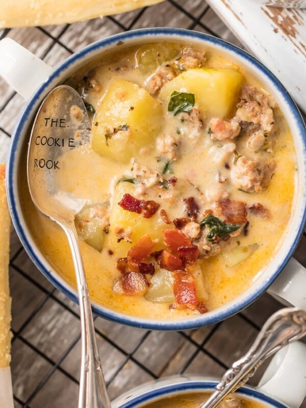 Instant Pot Zuppa Toscana is my new go-to Instant Pot Recipe! Every time we go to Olive Garden I get Zuppa Toscana and I just love that I can make this DELICIOUS copycat recipe at home in under 30 minutes! We first fell in love with this hearty and creamy soup at Olive Garden but I love this quick pressure cooker version even more. This Zuppa Toscana Recipe is loaded with sausage, bacon, potatoes, spinach, and so much flavor.