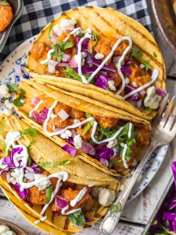 This BUFFALO SHRIMP TACOS RECIPE is tossed in a finger lickin good creamy buffalo sauce and easier than you can even imagine. Perfect for Cinco De Mayo, family night in, or game night with friends! Nothing is better than spicy crispy popcorn shrimp topped with all the fixings and wrapped in a corn tortilla. I'm obsessed.