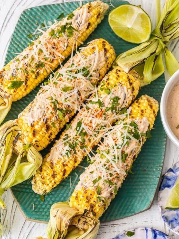 mexican grilled corn on a green platter