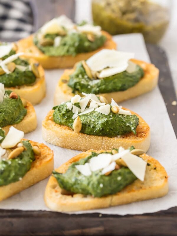 This Parmesan Spinach Dip Crostini is such a classy and unique appetizer to serve at your next party. Spinach Dip is loved by all, and now you don't need the chips to enjoy! Warm Parmesan Spinach Dip piled onto toasty French Bread is the ultimate in bruschetta recipes. This is one of our favorite game day or holiday recipes to make in a pinch.