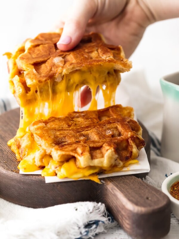 Waffle Sandwich? Yes! This fun and easy Apple Cheddar Waffle Grilled Cheese recipe is so delicious and only has 5 ingredients! The simple flavors of the maple dijon sauce blend perfectly with the creamy cheddar, crisp apples, and sweet waffles.