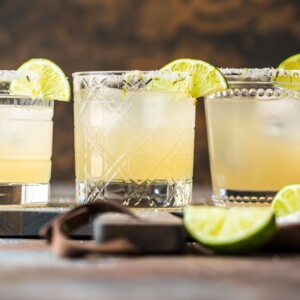 margaritas in glasses with lime garnish