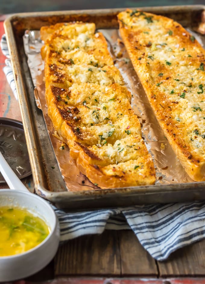 Homemade Garlic Bread is the absolute BEST Garlic Bread Recipe we have ever tried! If you want to learn How to Make Garlic Bread where the butter melts deep into the bread, creating the ultimate garlicky, carb filled side dish, you've come to the right place. We bake it, then broil it, to make it crispy on the outside while staying soft and buttery on the inside.