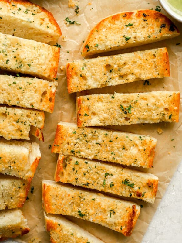 homemade garlic bread sliced on a brown paper