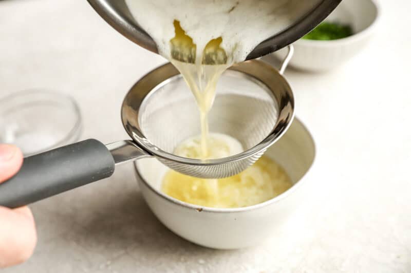 straining the infused garlic butter