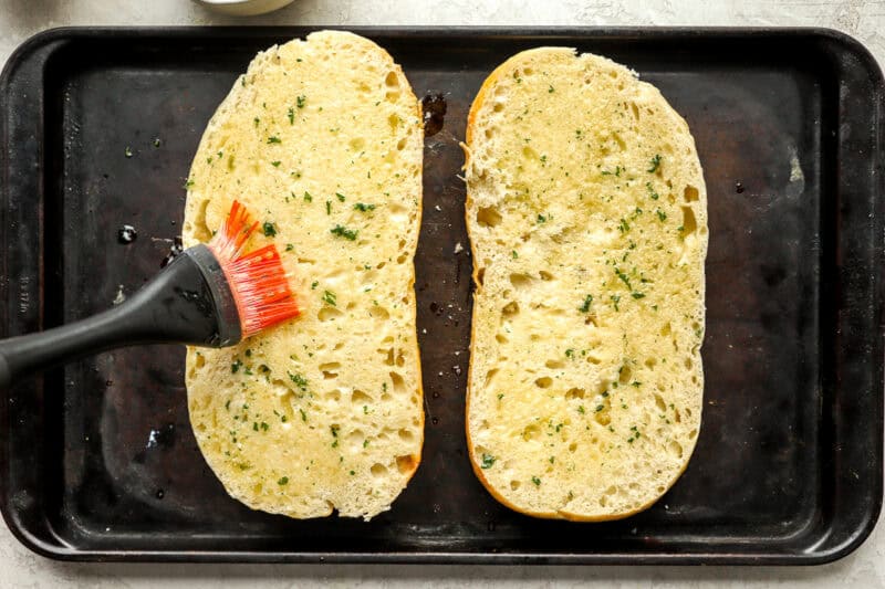 brush the garlic butter on the sliced loaves