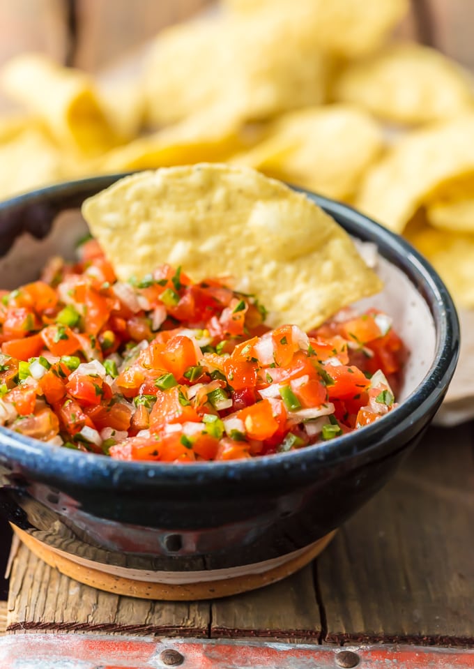 Homemade Pico de Gallo is a MUST MAKE for Summer and especially Cinco de Mayo. We love this EASY, quick, and flavorful Salsa Fresca that's loaded with fresh tomatoes, onion, garlic, lime juice, cilantro, and jalapeno peppers. This Pico de Gallo Recipe is the perfect topping for steak or chicken or is perfect for chips and salsa. Best recipe for Summer!