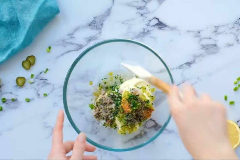 combining all ingredients for tartar sauce in a large bowl.