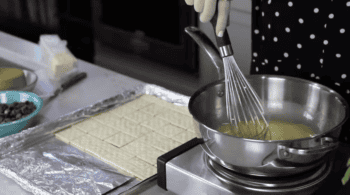 melting butter in a saucepan with a whisk.