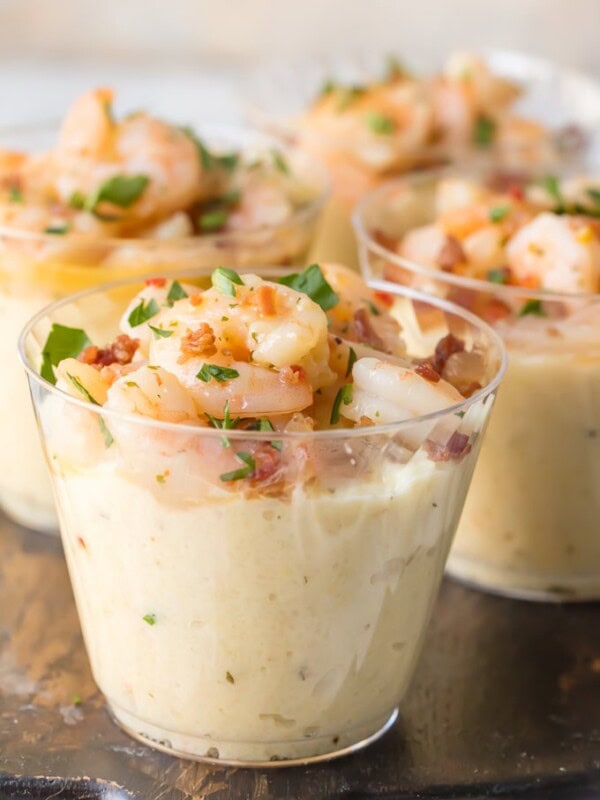 shrimp and grit cups on a wooden cutting board