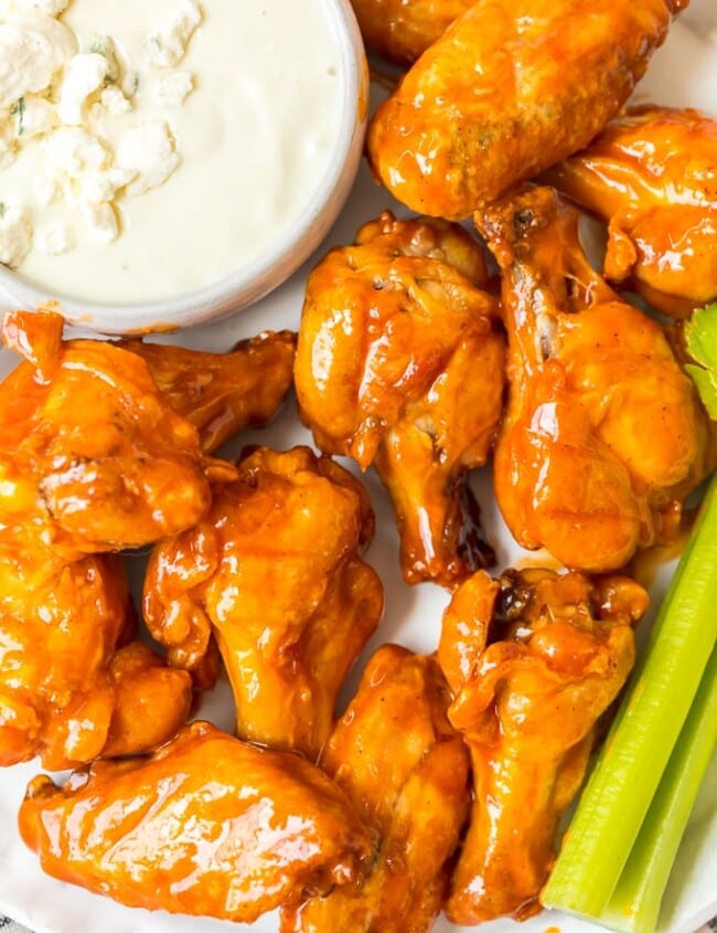 Baked Buffalo Wings are a tasty alternative to typical fried buffalo wings (and a bit healthier too!). These crispy baked chicken wings are covered in our homemade buffalo sauce for the perfect hot and spicy flavor. Baked Buffalo Chicken Wings are a real crowd pleaser and perfect for game day parties. You're going to love these crispy oven baked buffalo wings!