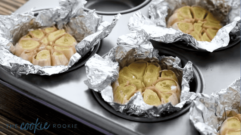 roasted heads of garlic in a muffin tin.