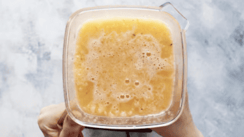 blended peach lemonade in a blender.