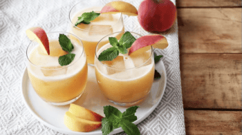 peach lemonade in glasses on a plate.