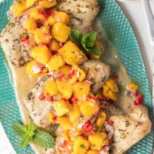 Sangria Chicken with Mango Salsa is a fresh and delicious dinner option. Combine a sangria butter sauce with marinated chicken breasts, and top it off fresh fruity mango salsa. The result is Mango Salsa Chicken, a tasty summer-time dish full of flavor!