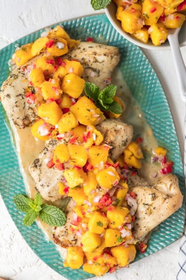 Sangria Chicken with Mango Salsa is a fresh and delicious dinner option. Combine a sangria butter sauce with marinated chicken breasts, and top it off fresh fruity mango salsa. The result is Mango Salsa Chicken, a tasty summer-time dish full of flavor!