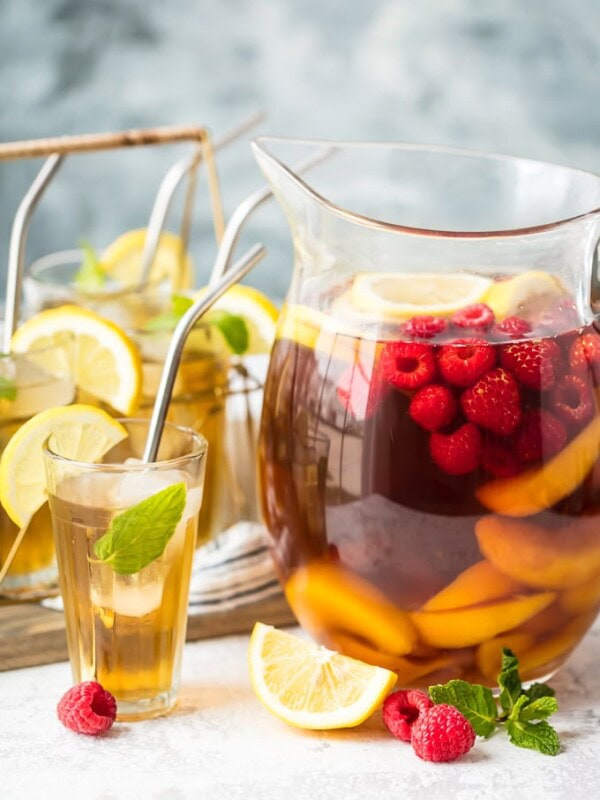 A bowl of fruit on a table, with Sangria