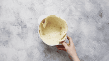 forming a tortilla into a bowl.