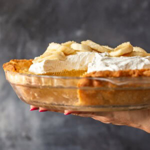 Banana Cream Pie is a creamy, delicious dessert filled with custard and fresh bananas. It's the perfect holiday recipe for Christmas, Easter, or Thanksgiving. This easy banana cream pie recipe is so rich and so tasty, everyone will love it!