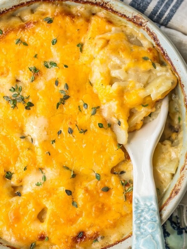 Cheesy Scalloped Potatoes are the perfect side dish for holidays. This easy cheesy scalloped potatoes recipe is creamy, delicious, and easy to make ahead of time!