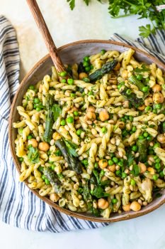 Green Goddess Pasta Salad is the stuff Summer Recipe dreams are made of! This healthy Pasta Salad Recipe is full of flavor and oh so easy to throw together. Loaded with asparagus, peas, chickpeas, pine nuts, and the ultimate green goddess dressing, this Green Goddess Pasta Salad Recipe is perfect as a side dish, main course, or even guilt-free late night snack.