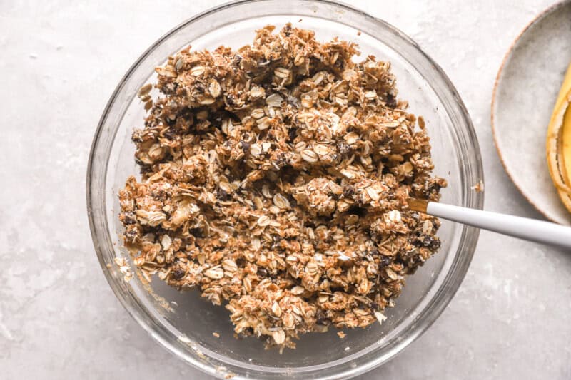 energy ball mixture in a glass bowl with a spoon.