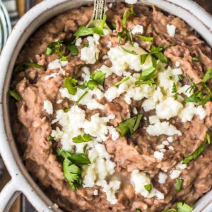 This homemade refried beans recipe is simple and absolutely delicious. Refried beans are the perfect side dish for your favorite Tex-Mex dishes, like tacos, cheesy chicken, nachos, burritos, & more!