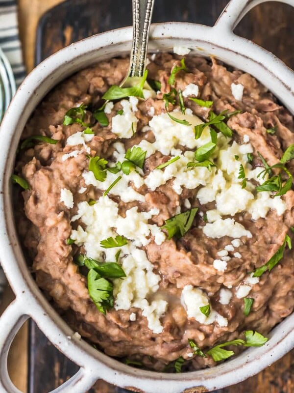 This homemade refried beans recipe is simple and absolutely delicious. Refried beans are the perfect side dish for your favorite Tex-Mex dishes, like tacos, cheesy chicken, nachos, burritos, & more!