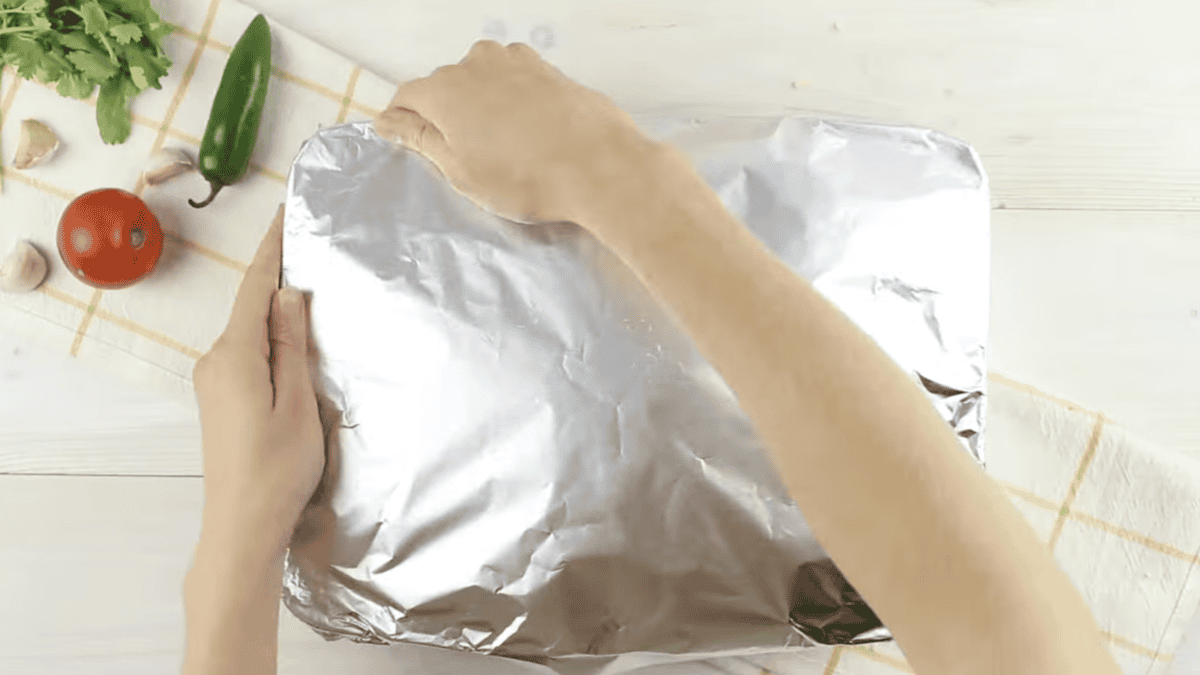 covering a casserole dish with aluminum foil.