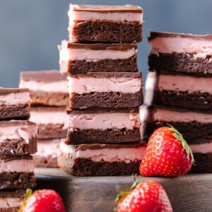 STRAWBERRY BROWNIES are perfect for Valentine's Day! This Chocolate Covered Strawberry Brownie Recipe is a mix of soft chocolate-y brownie, creamy strawberry filling, & a layer of melted chocolate.