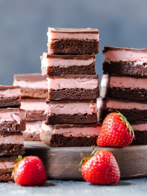 STRAWBERRY BROWNIES are perfect for Valentine's Day! This Chocolate Covered Strawberry Brownie Recipe is a mix of soft chocolate-y brownie, creamy strawberry filling, & a layer of melted chocolate.