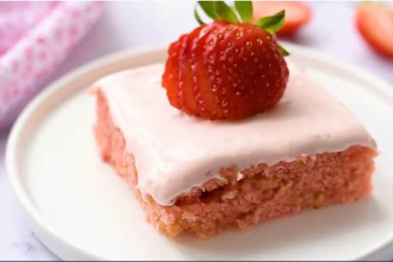 spread over the cool cake and served in a glass plate with extra strawberry on top