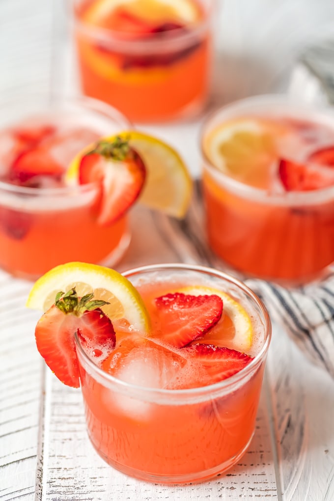 4 short glasses filled with strawberry lemonade party punch