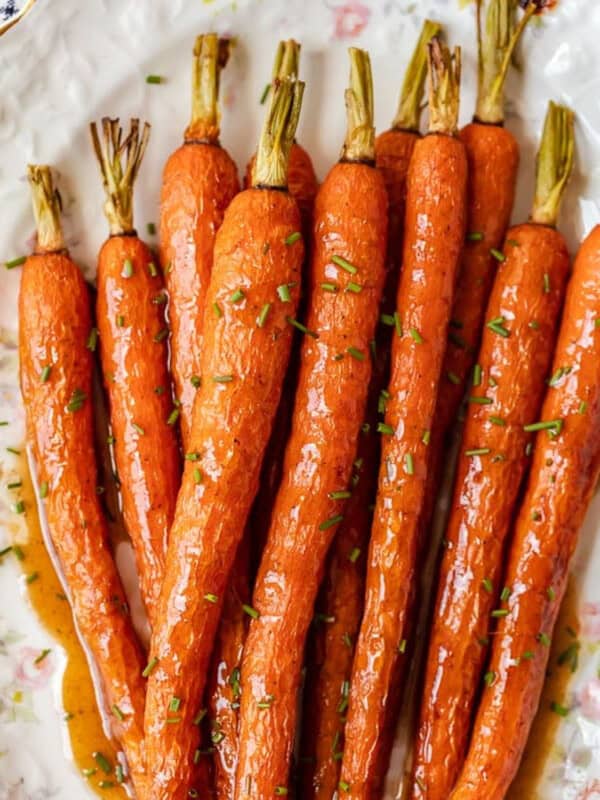 Honey glazed carrots on a white plate.