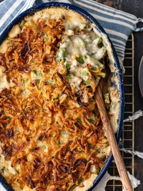 A green bean casserole dish with a spoon on top.