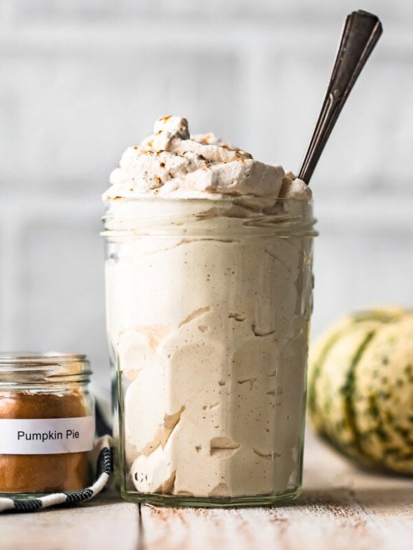 Pumpkin Flavored Whipped Cream is exactly what we all need for fall! Top of all of your favorite desserts (pumpkin pie, pumpkin cheesecake, pumpkin anything) with this Pumpkin Spice Whipped Cream recipe.