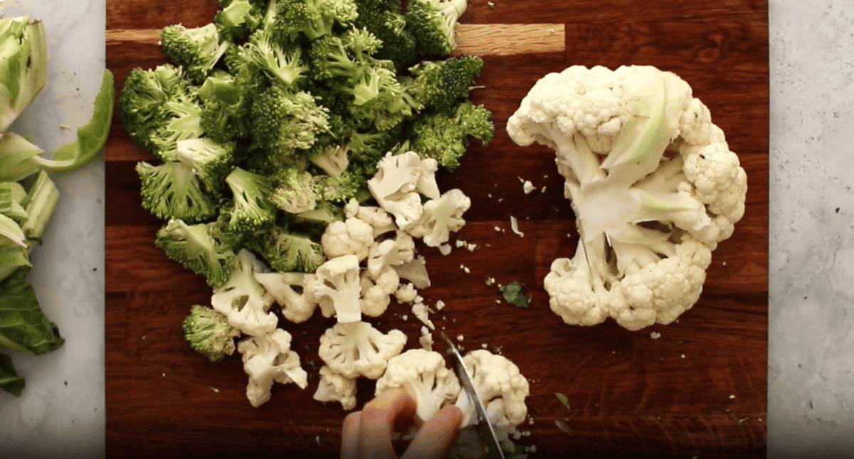 chopped broccoli and cauliflower on a cutting board.