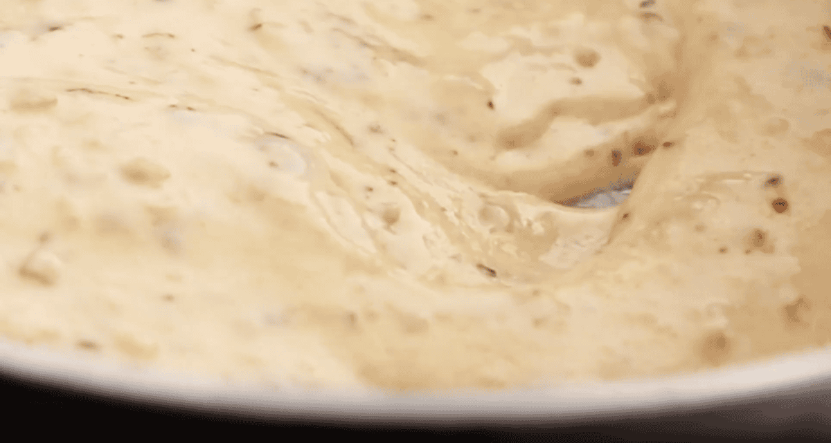 thick creamy cheese sauce in a pan.