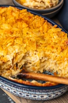 Cheesy Potato Casserole is the ideal holiday side dish recipe for anyone that loves cheese and potatoes. This hash brown potato casserole recipe is super easy, super cheesy, and topped off with a crunchy potato chip topping!