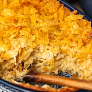 Cheesy Potato Casserole is the ideal holiday side dish recipe for anyone that loves cheese and potatoes. This hash brown potato casserole recipe is super easy, super cheesy, and topped off with a crunchy potato chip topping!