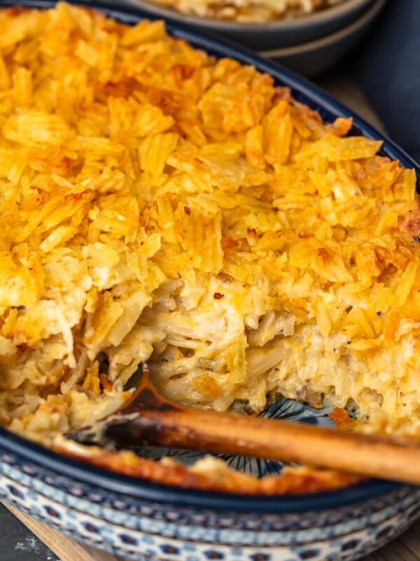 Cheesy Potato Casserole is the ideal holiday side dish recipe for anyone that loves cheese and potatoes. This hash brown potato casserole recipe is super easy, super cheesy, and topped off with a crunchy potato chip topping!