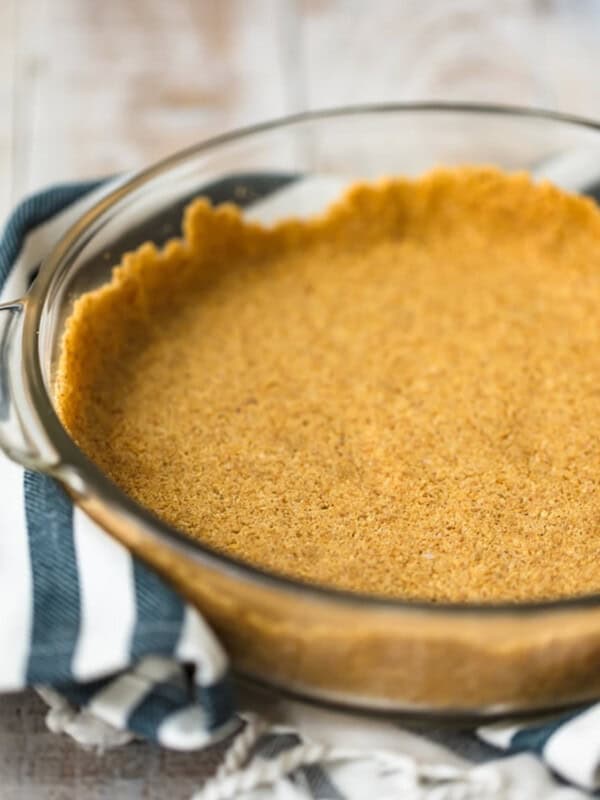 A savory pumpkin pie in a glass dish on a table.