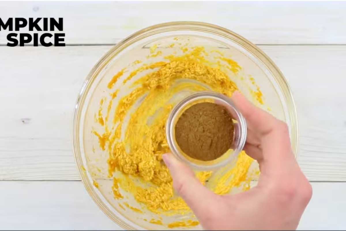 overhead shot of preparing pumpkin filling in a glass bowl