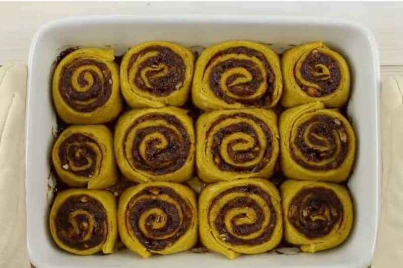 Cut rolls are risen in the baking sheet. ready to bake.